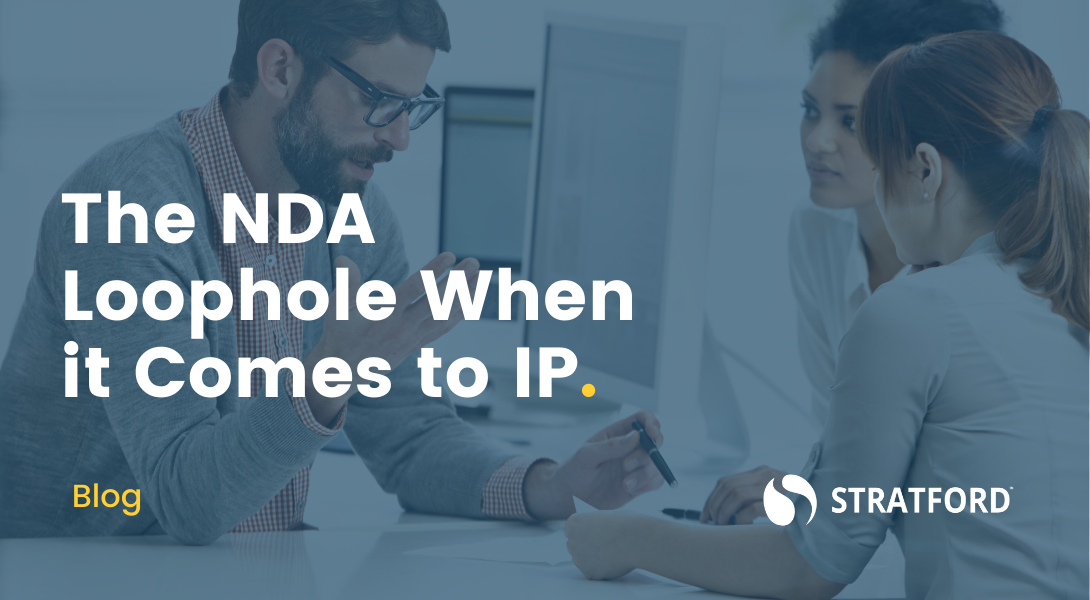 Man holding a pen pointing out a clause in an NDA to two female coworkers with text overlay "The NDA Loophole When it Comes to IP."