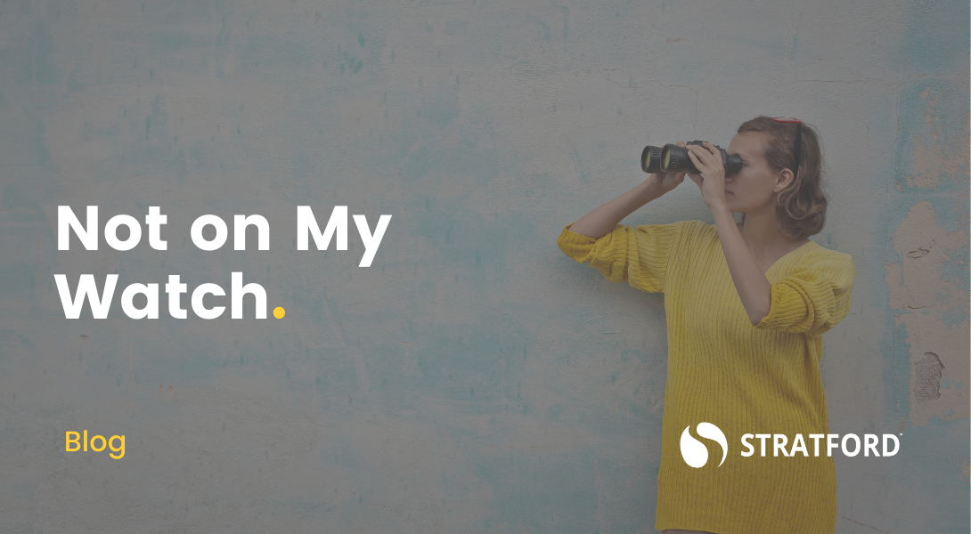 Woman standing against a concrete wall holding a pair of binoculars to her eyes looking to the left. Text overlay "Not on My Watch."